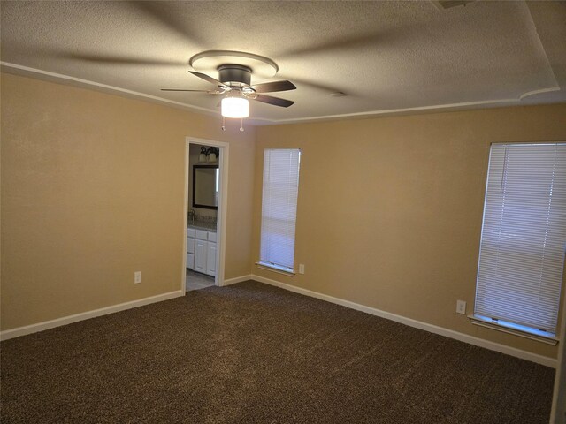 carpeted empty room with a textured ceiling and ceiling fan