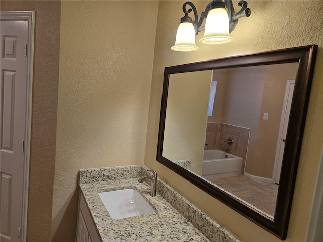 bathroom featuring a washtub and vanity