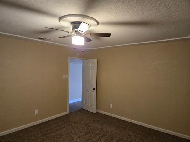 carpeted spare room with ceiling fan and a textured ceiling