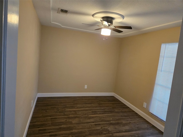 spare room featuring a textured ceiling, dark hardwood / wood-style floors, and ceiling fan