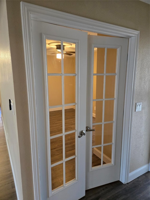 entryway with ceiling fan, french doors, and dark wood-type flooring