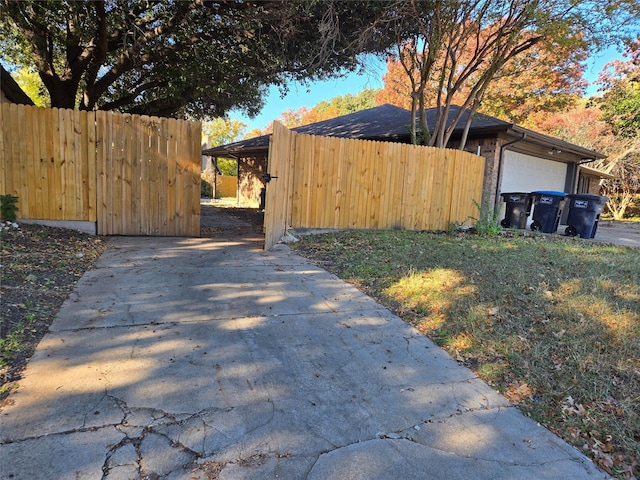 view of side of property featuring a yard and a garage