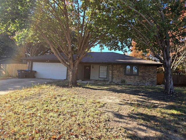 single story home with a front yard and a garage