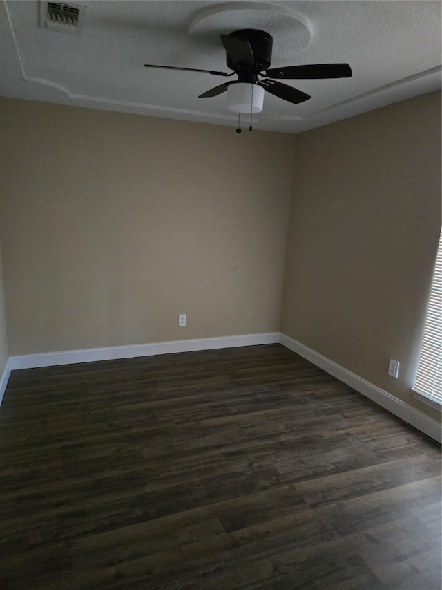 unfurnished room with ceiling fan, dark hardwood / wood-style flooring, and a textured ceiling