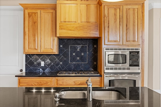 kitchen featuring ornamental molding, appliances with stainless steel finishes, sink, and backsplash