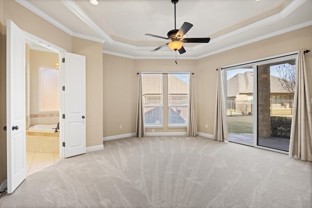 carpeted spare room featuring crown molding, ceiling fan, and a tray ceiling