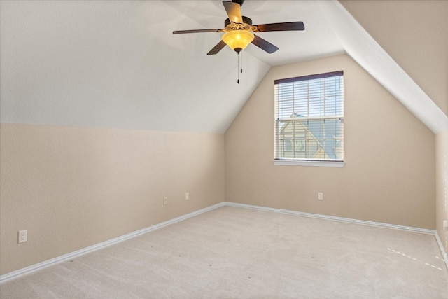 additional living space featuring ceiling fan, light carpet, and vaulted ceiling