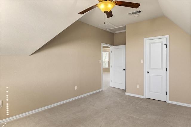 bonus room featuring ceiling fan, lofted ceiling, and light carpet