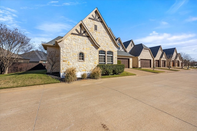 view of front of home with a front yard and a garage