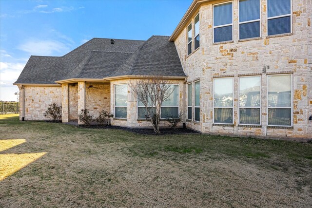 rear view of property featuring a lawn