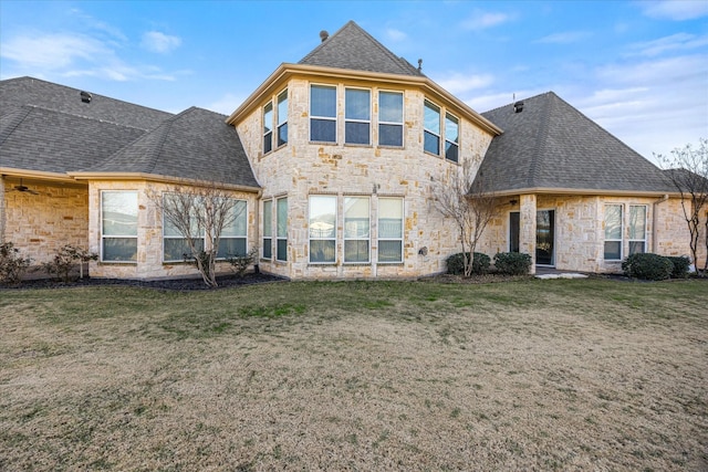 rear view of property with a yard