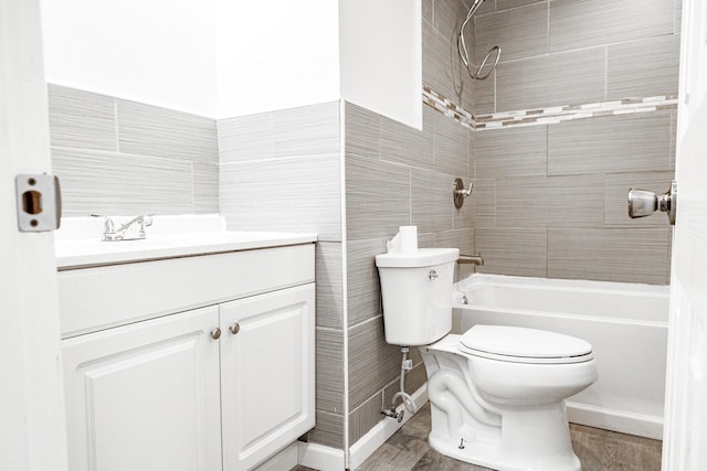 full bathroom with vanity, tile walls, washtub / shower combination, hardwood / wood-style floors, and toilet