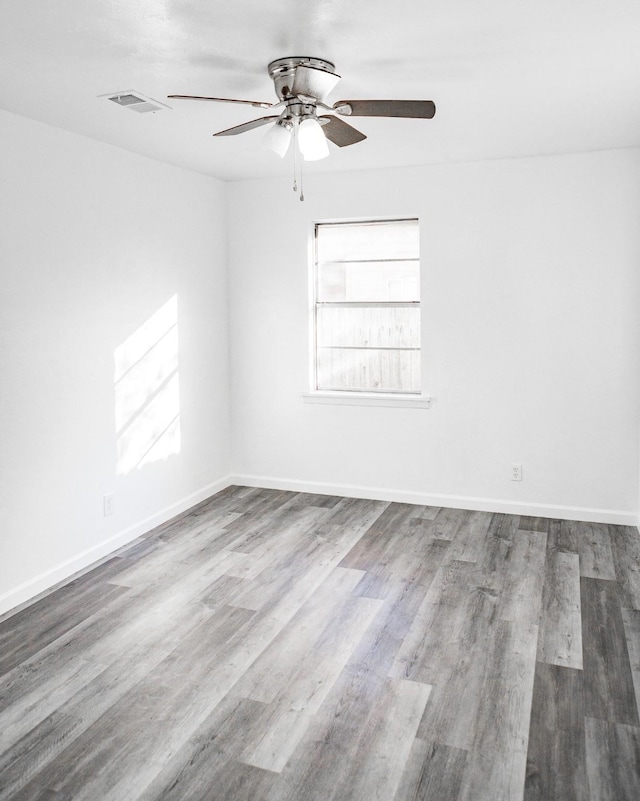 spare room with hardwood / wood-style floors and ceiling fan