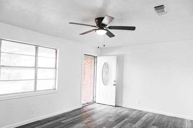 empty room featuring ceiling fan and dark wood-type flooring