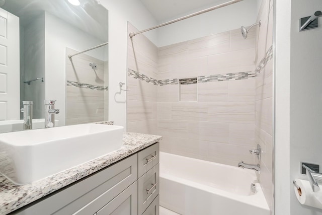 bathroom with vanity and tiled shower / bath