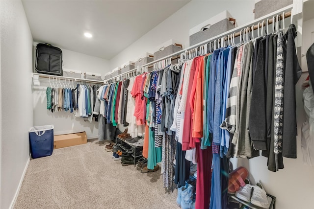 walk in closet with carpet