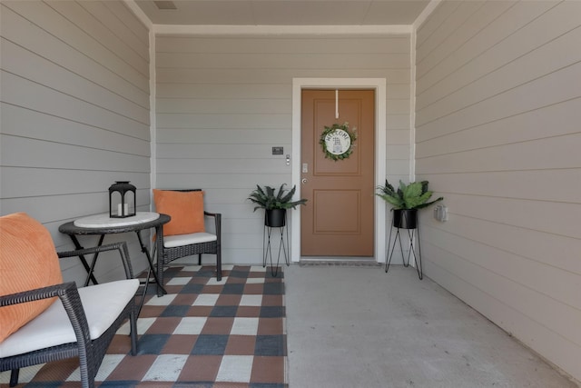 view of exterior entry with a porch