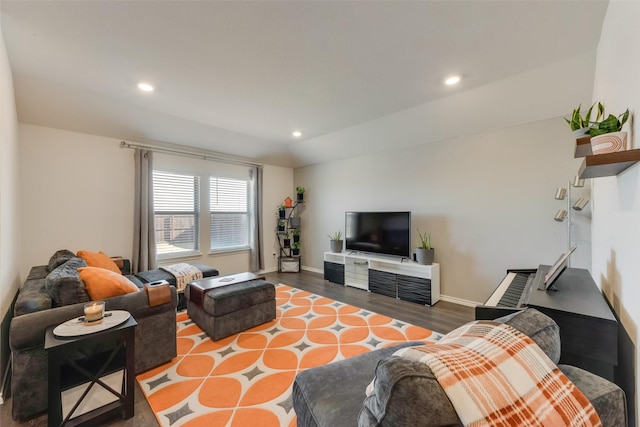 living room with recessed lighting, lofted ceiling, baseboards, and wood finished floors