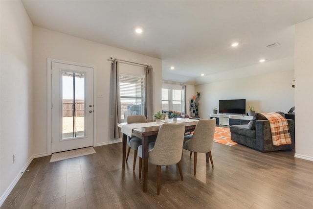 dining room featuring baseboards, wood finished floors, and recessed lighting