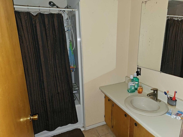 bathroom featuring tile patterned floors, shower / bathtub combination with curtain, and vanity