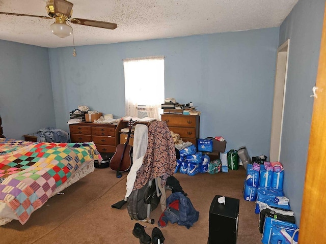 bedroom featuring ceiling fan, cooling unit, carpet floors, and a textured ceiling