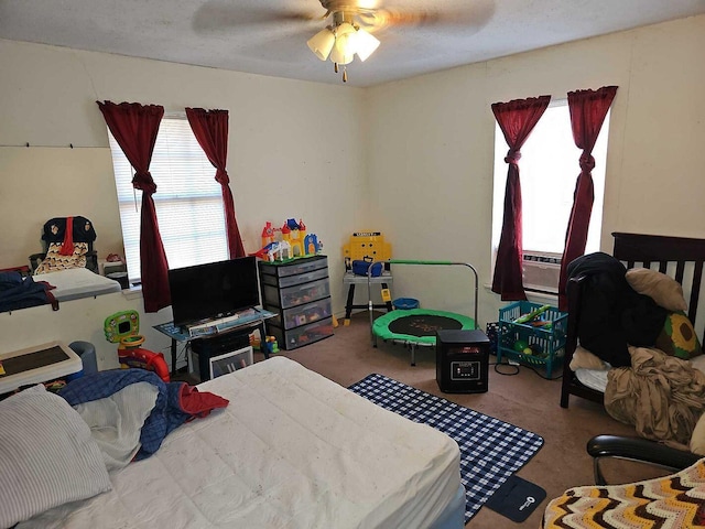 bedroom with cooling unit, ceiling fan, and carpet floors