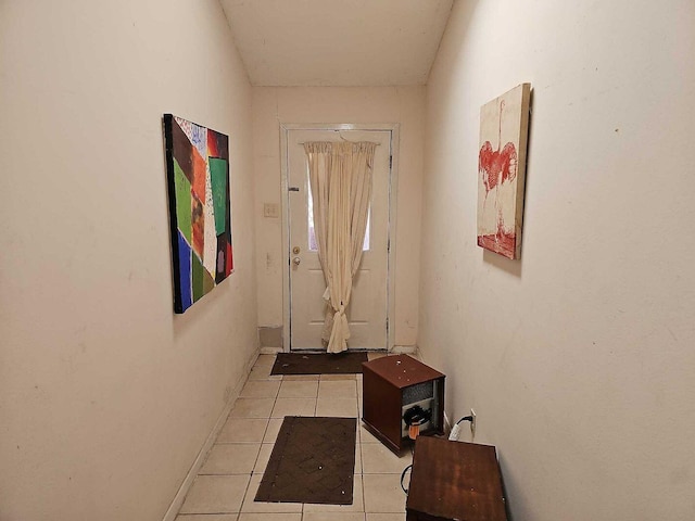 doorway to outside with light tile patterned floors