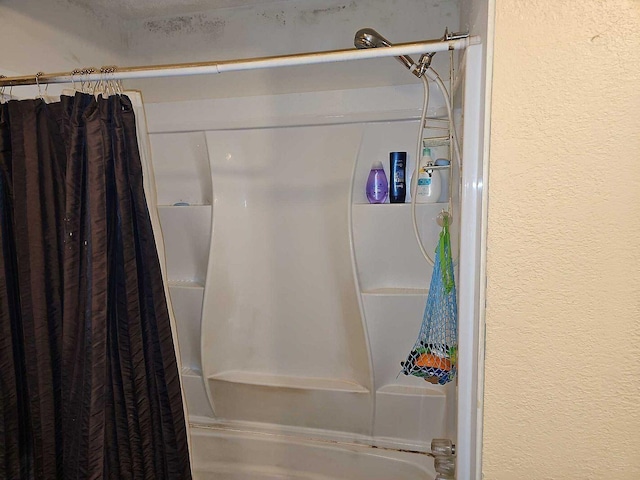 bathroom with shower / bath combination with curtain