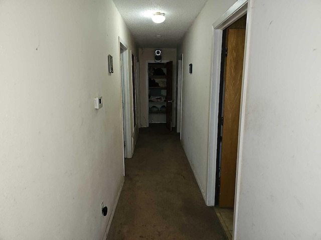 hallway featuring a textured ceiling