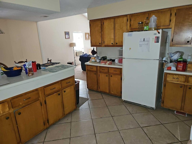 kitchen featuring light tile patterned flooring and white refrigerator