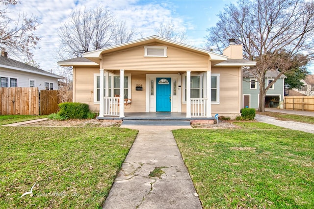 bungalow-style home featuring a porch and a front lawn