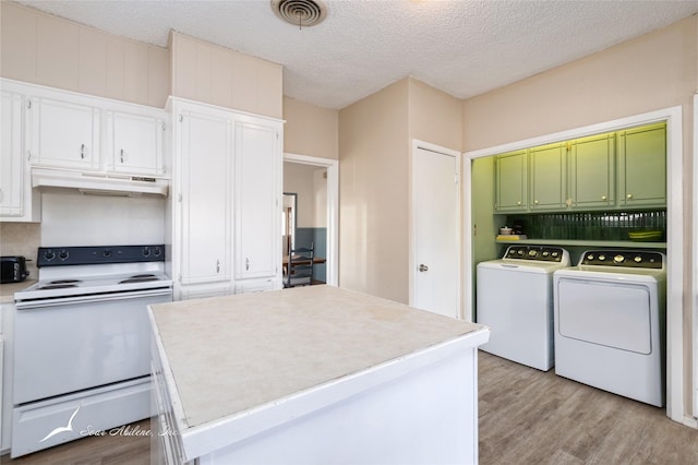 kitchen featuring a textured ceiling, white cabinets, independent washer and dryer, light hardwood / wood-style floors, and white range with electric cooktop