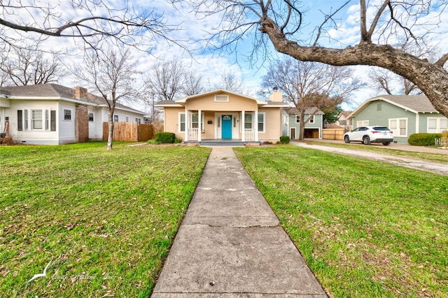 view of front of property with a porch and a front lawn