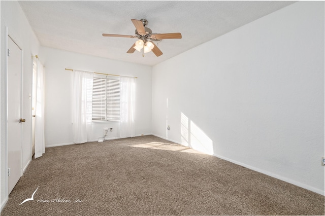 spare room featuring ceiling fan and carpet floors