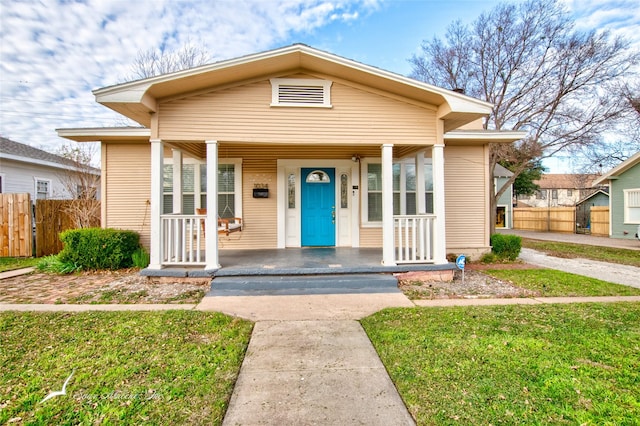 bungalow-style home with a porch and a front lawn