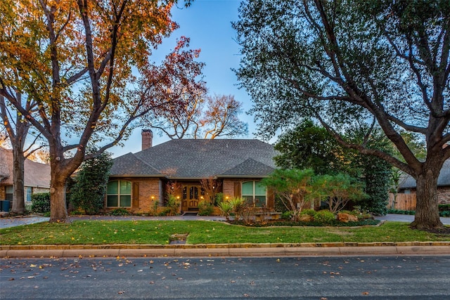 ranch-style home with a front lawn