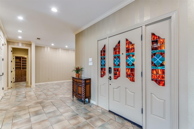 entryway with light tile patterned floors and crown molding