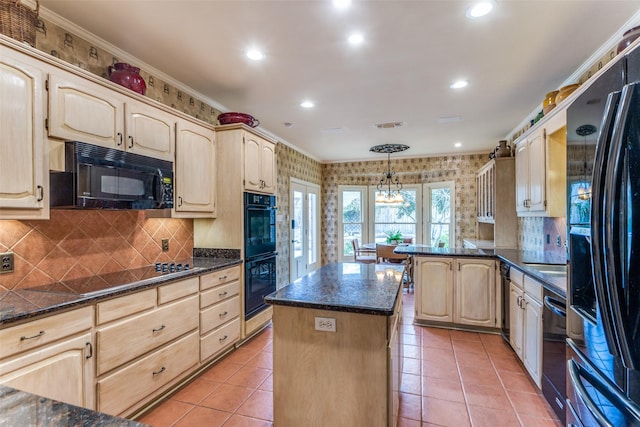 kitchen featuring hanging light fixtures, a kitchen island, black appliances, light tile patterned flooring, and light brown cabinets