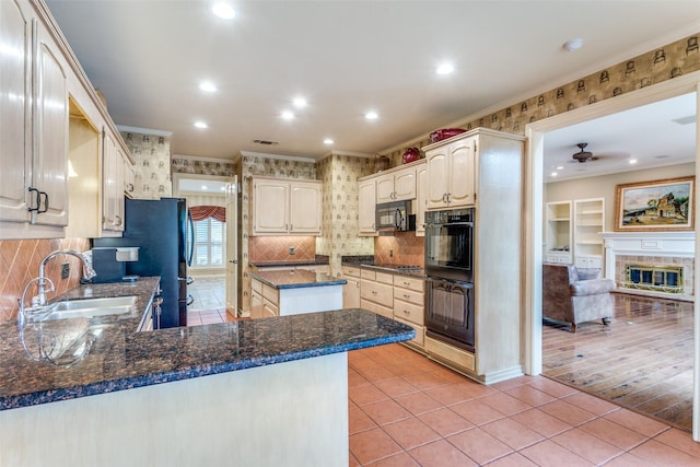 kitchen with sink, crown molding, light tile patterned floors, kitchen peninsula, and black appliances