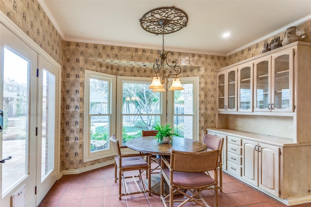 dining space with crown molding, plenty of natural light, and light tile patterned flooring