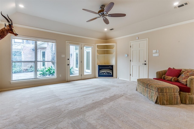 carpeted living room with crown molding and ceiling fan