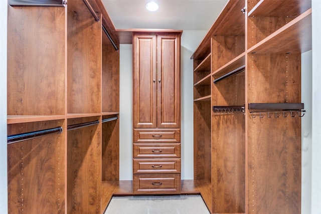 walk in closet with light tile patterned floors