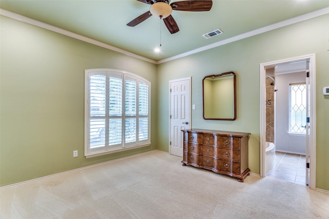 unfurnished bedroom with light carpet, ornamental molding, ceiling fan, and ensuite bathroom