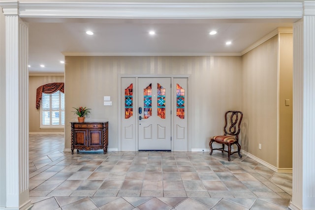 tiled entrance foyer featuring crown molding