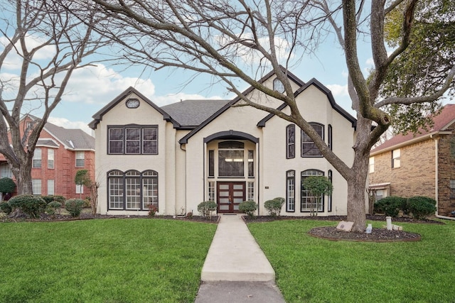 view of front facade with a front lawn and french doors