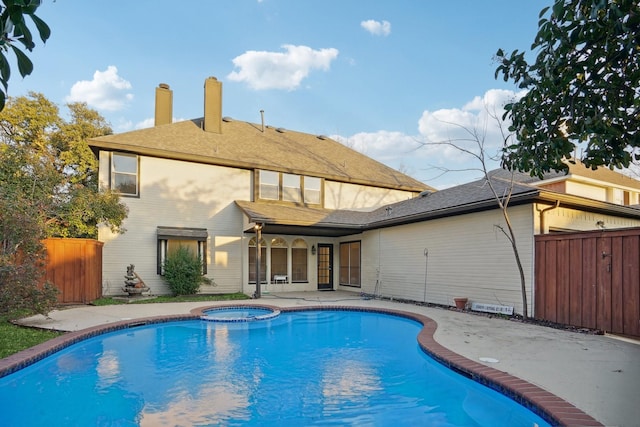 view of pool featuring a patio area and an in ground hot tub