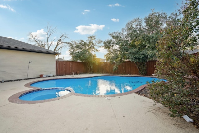 view of swimming pool featuring an in ground hot tub and a patio area