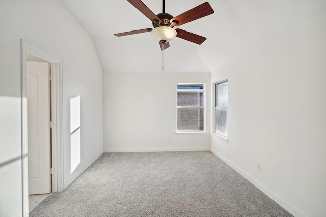 carpeted spare room featuring ceiling fan and lofted ceiling