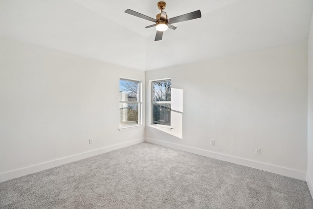 spare room with ceiling fan and carpet