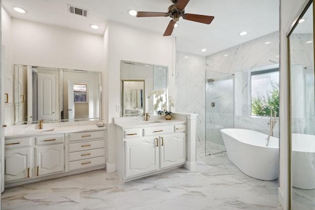 bathroom featuring ceiling fan, vanity, and plus walk in shower